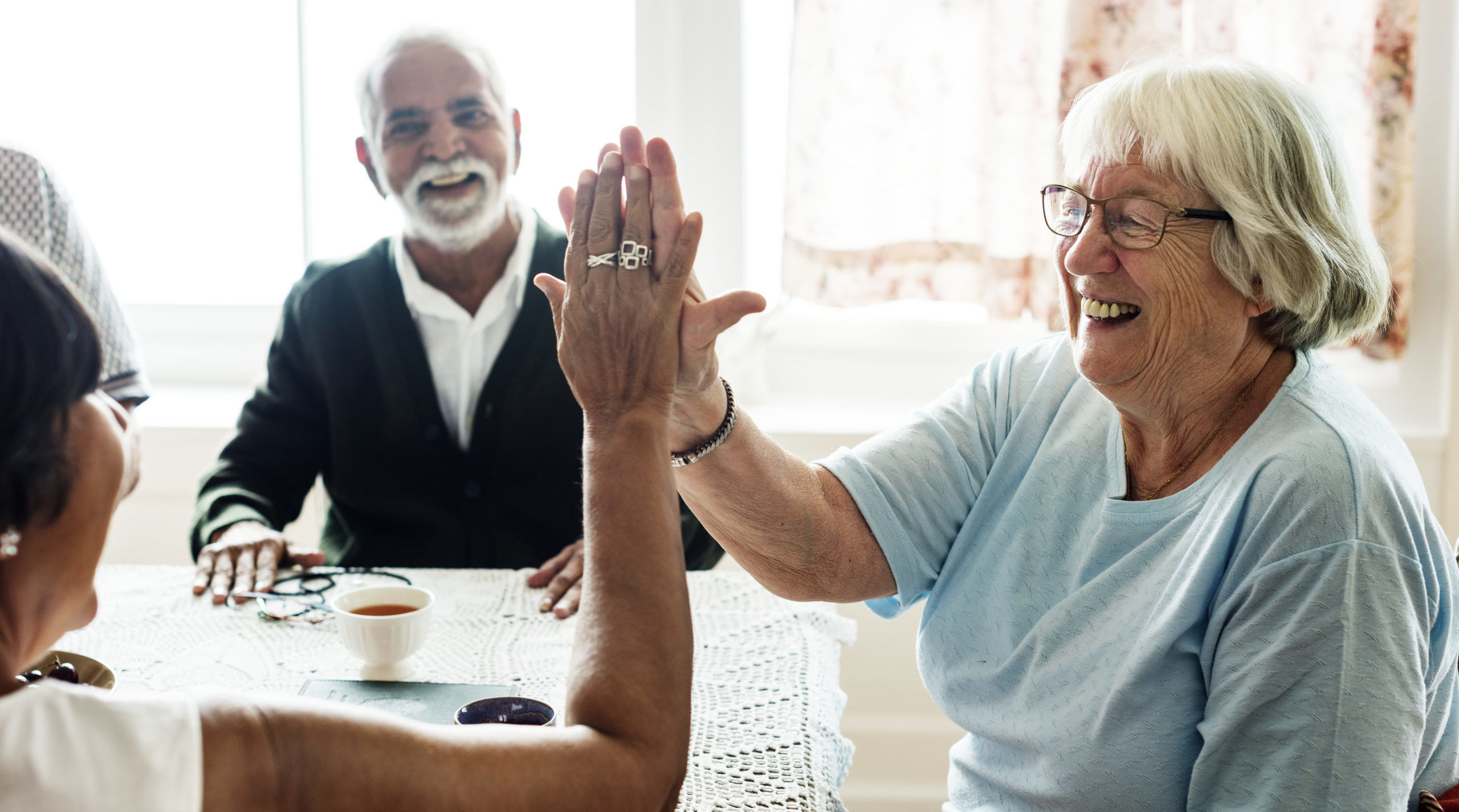 Freepik Senior women giving each other high five