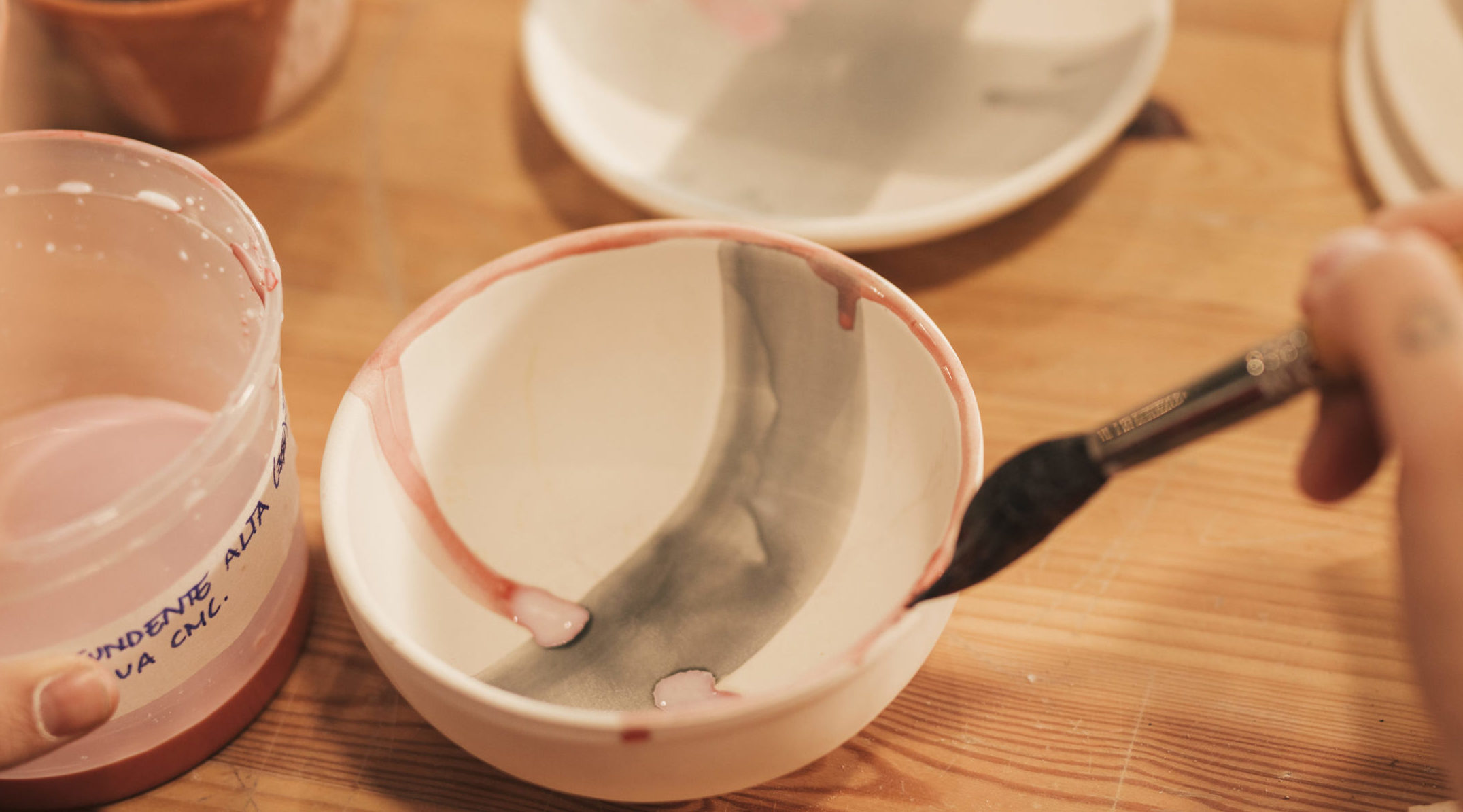 freepik close-up-female-s-hand-painting-ceramic-bowl-with-paintbrush
